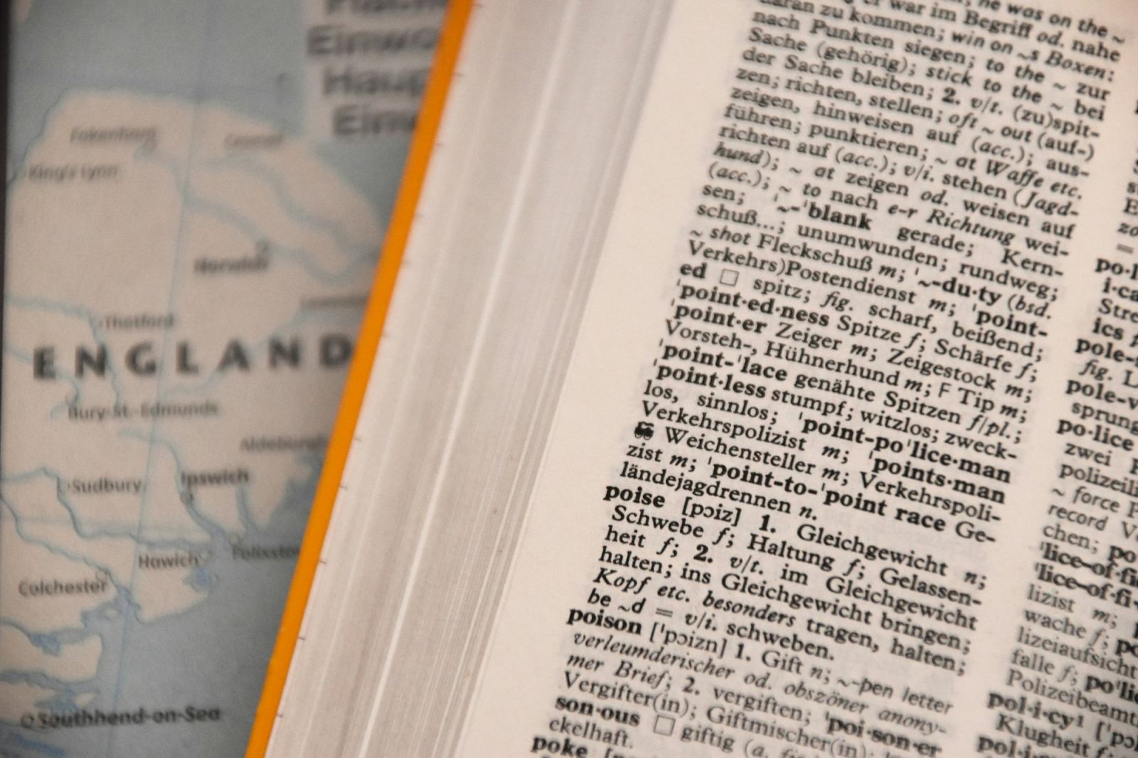 Open dictionary page beside a map of England