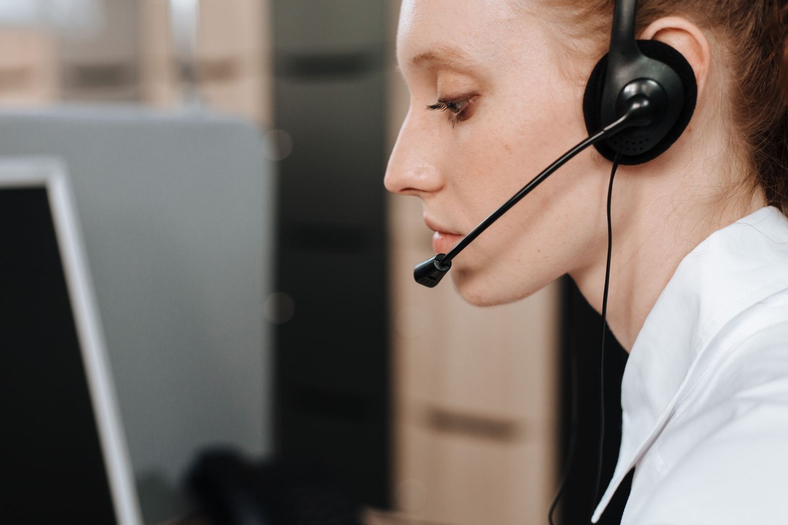 Close-up side profile of a woman wearing a call center headset