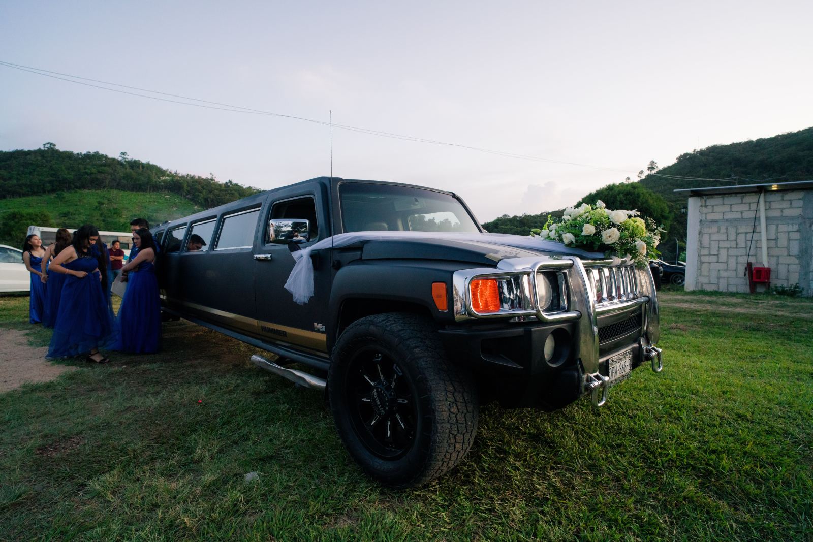 Black stretch Hummer limousine decorated with flowers for a wedding party