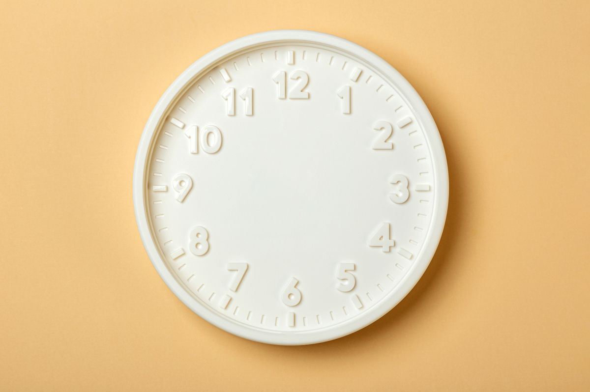 Minimalist white wall clock, representing on-time will-call return trip pickups