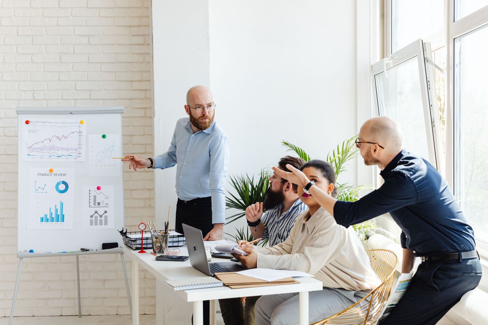 Presenter pointing to a finance review chart during an office meeting