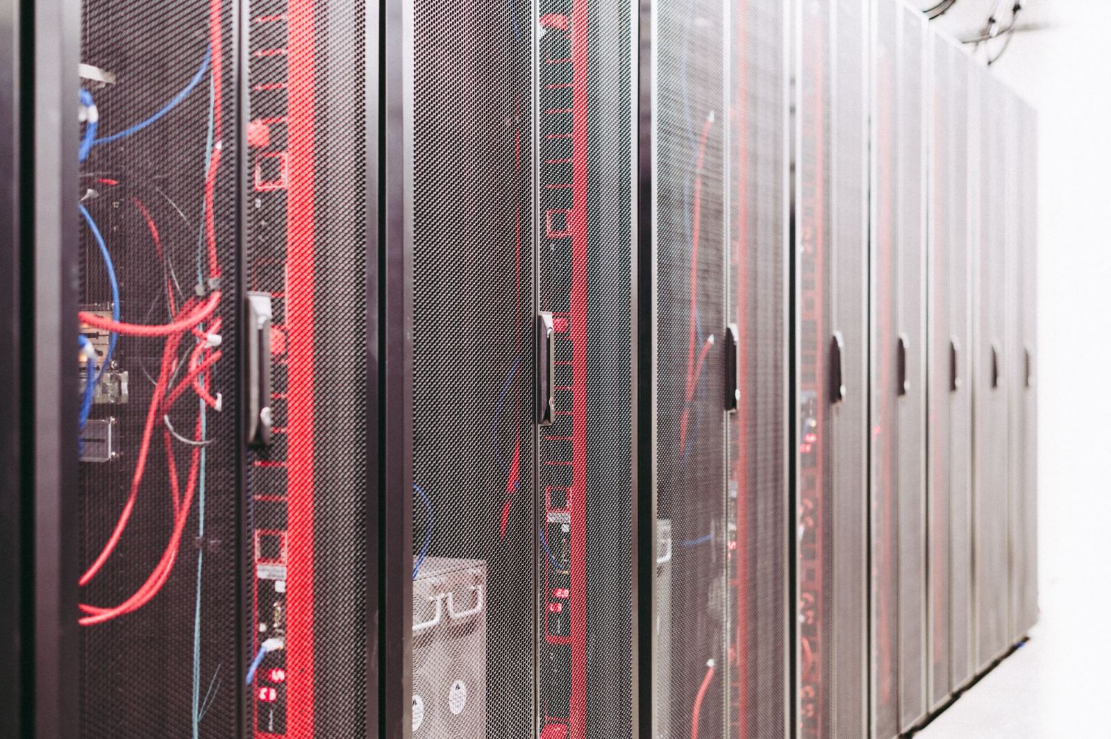 Row of server racks with cabling in a data center corridor