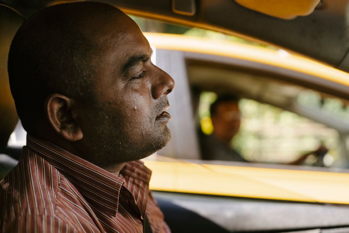 Close-up profile of a taxi driver focused on the road