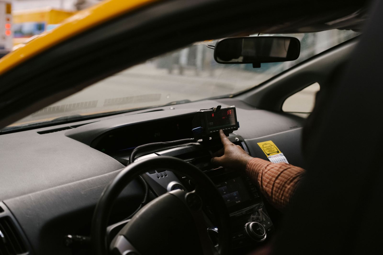 Close-up of a digital taxi meter mounted on the dashboard