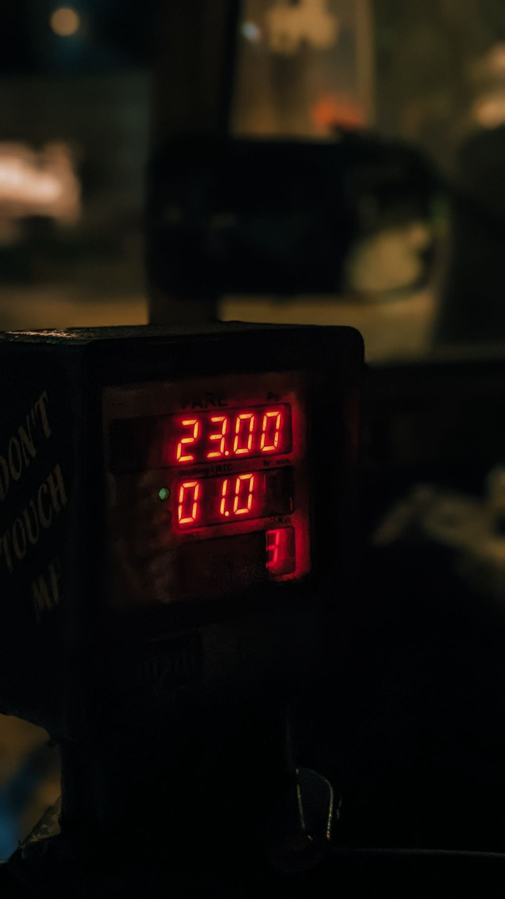 Close-up of an illuminated taxi meter display showing the fare amount