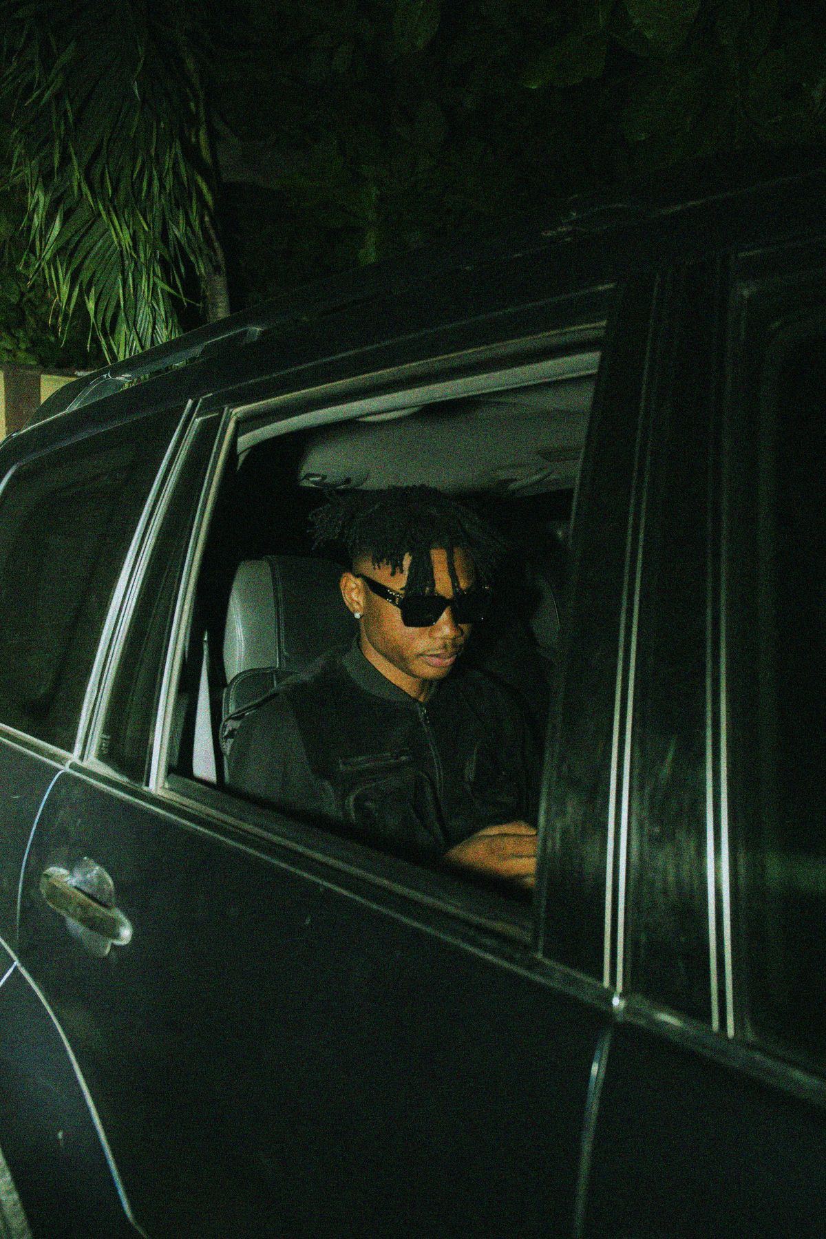 Passenger in the back seat of a car at night