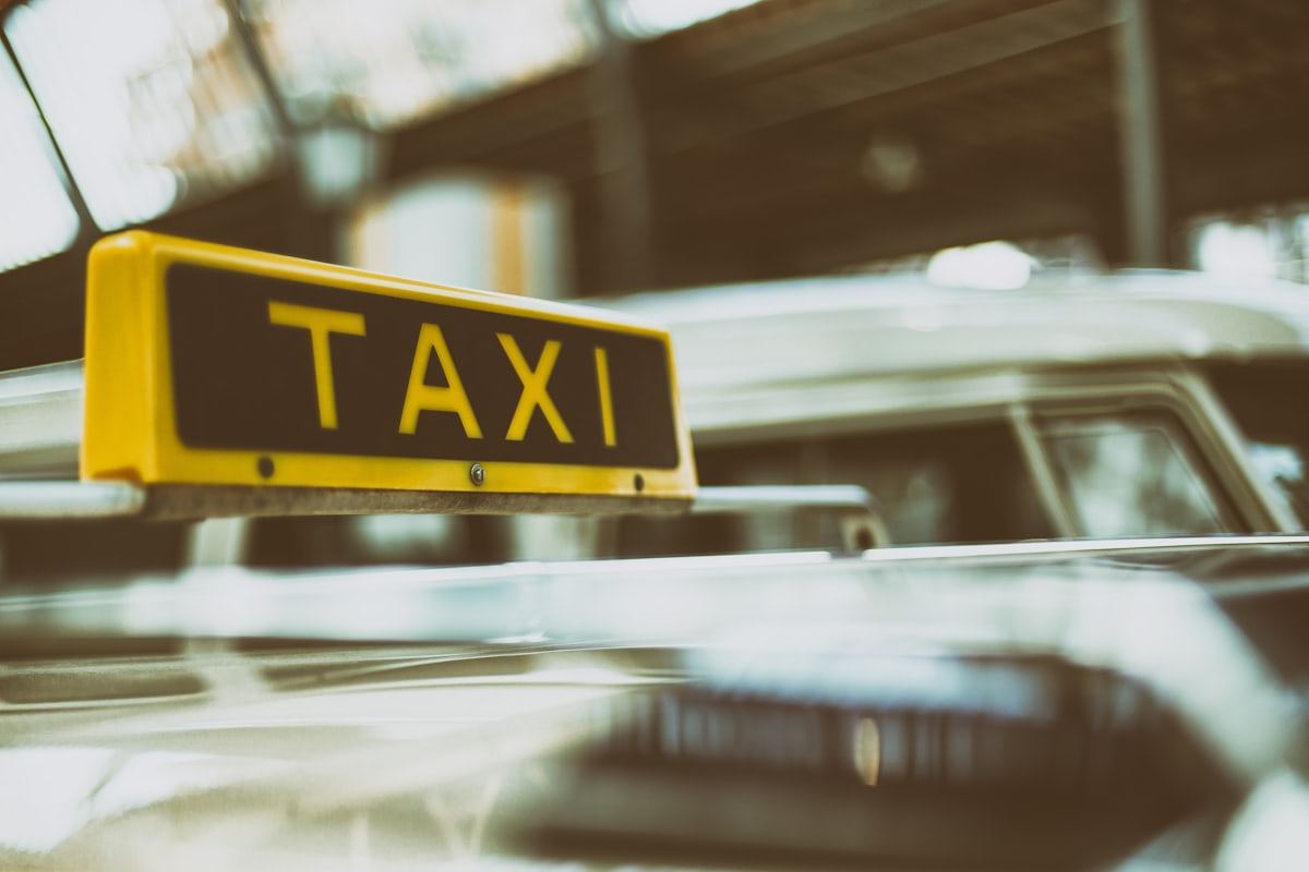 Close-up of an illuminated TAXI roof sign on a cab