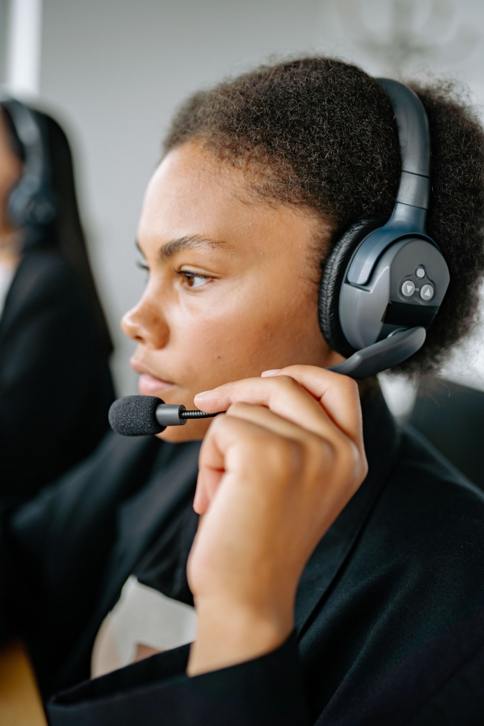 Close-up of a dispatcher wearing a headset while coordinating a call