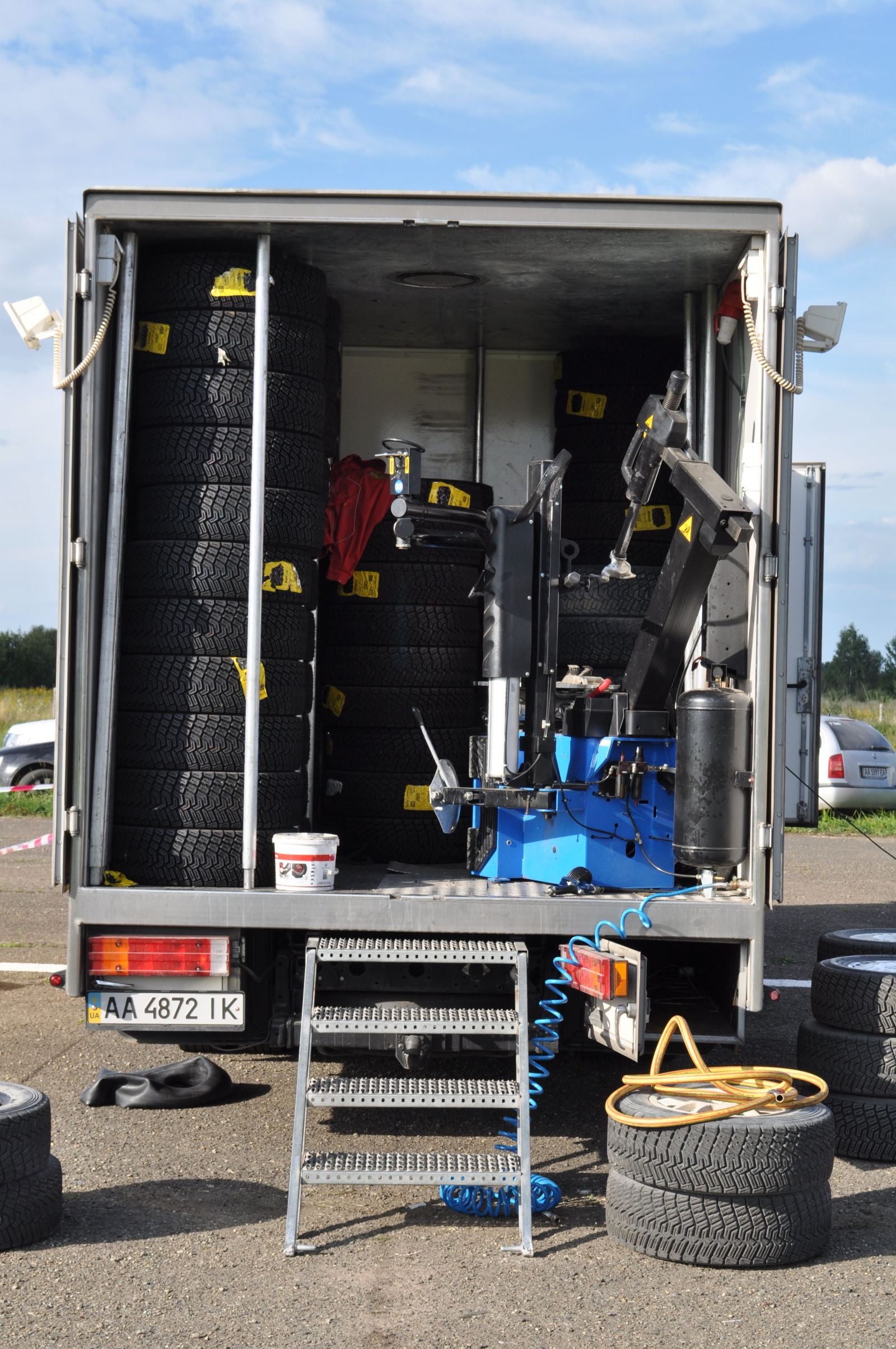 Interior of a mobile tire service truck stocked with tires and equipment