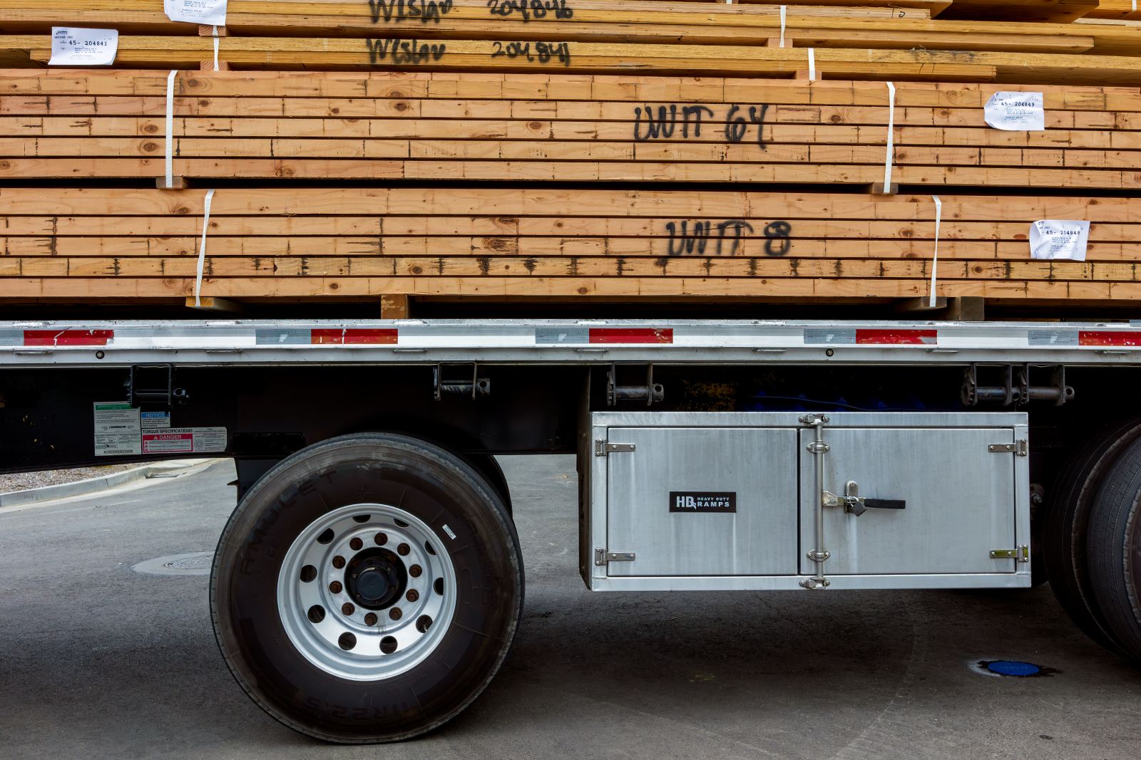 Close-up of a flatbed truck loaded with stacked lumber