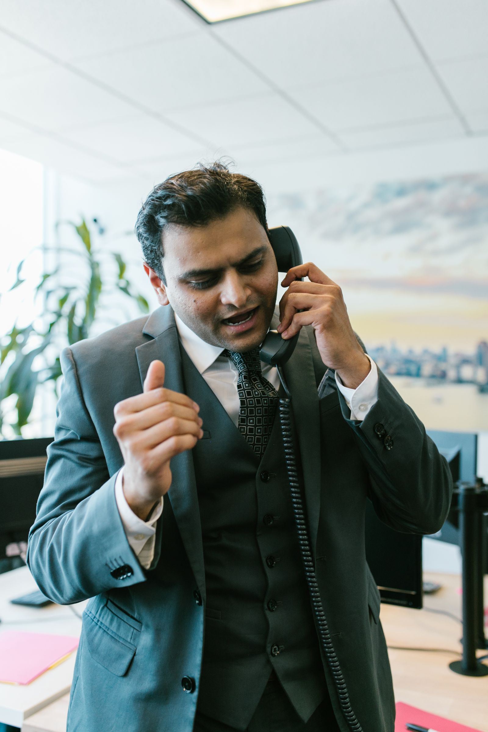 Energetic salesman on a phone call in an office