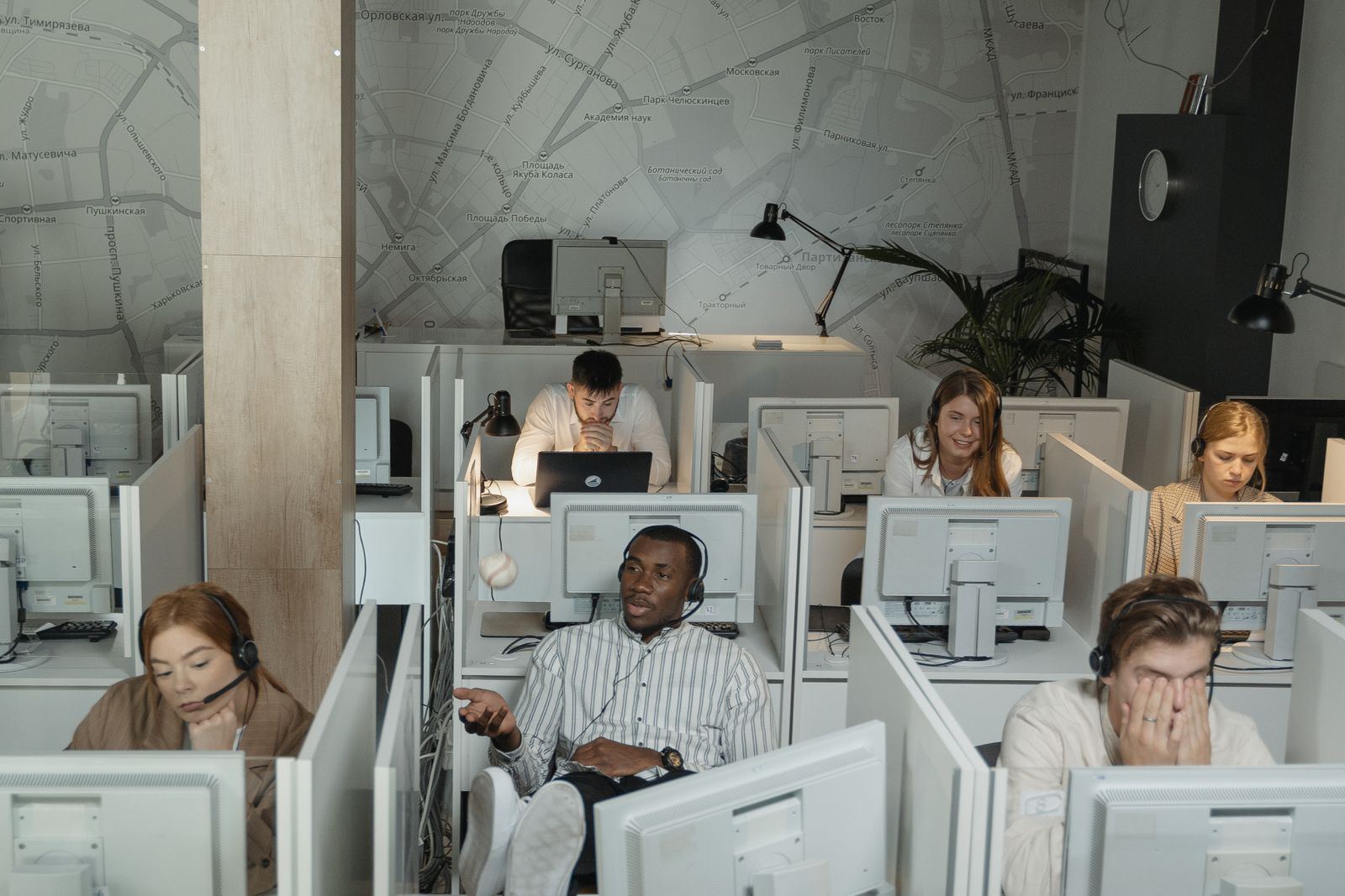 Busy call center floor with multiple agents wearing headsets simultaneously