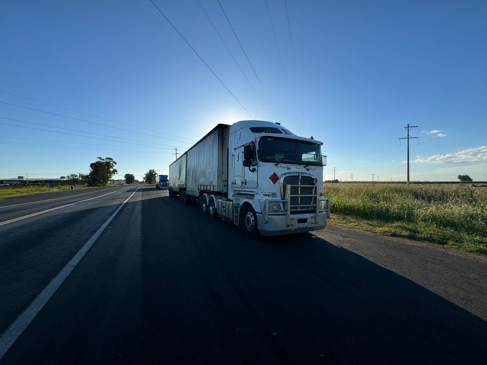 Semi-truck freight carrier on the highway, representing outsourced trucking dispatch support